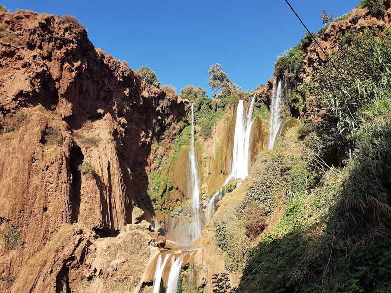 A waterfall in a steep green valley in Morocco’s Atlas region
